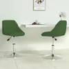 Two dark green velvet swivel chairs are shown in a dining area with a white table. Produktbild-Vorschau