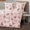 A bed with bedding featuring a deer pattern. Produktbild-Vorschau