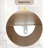 A close-up view of a furniture component, likely a shelf or cabinet, showing an anti-tip bracket. The background is blurred, suggesting an indoor setting. Voir les images du produit