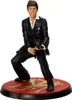A figurine of Tony Montana from Scarface, posed with a gun on a circular base. Podgląd zdjęcia produktu