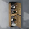 A tall, narrow bathroom cabinet with its doors open, mounted on a gray wall. The cabinet has a wood-grain finish and contains various toiletries and folded towels on its shelves. Produktbild-Vorschau