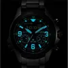 A close-up of a glowing watch face in the dark. Produktbild-Vorschau