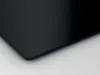 A close-up view of the corner of a black glass stovetop. Produktbild-Vorschau