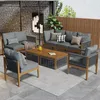 An outdoor living space with a sectional sofa, chairs, and coffee tables arranged on a rug. Voir les images du produit