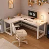A white L-shaped desk with a computer, keyboard, mouse, and a desk lamp. Podgląd zdjęcia produktu
