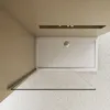 A top-down view of a shower tray and a glass shower screen in a bathroom. Produktbild-Vorschau