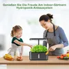 A woman and a child are tending to a hydroponic herb garden indoors. Produktbild-Vorschau