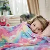 A young girl is tucked into bed under a colorful unicorn-themed blanket. Náhľad obrázku produktu