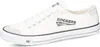 A white canvas sneaker with a gray logo on the side. Produktbild-Vorschau