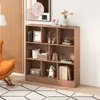 A wooden bookshelf filled with decorative items and books, placed in a room with a chair and a painting. Náhľad obrázku produktu