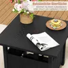 A black side table with a magazine, pancakes, and a flower arrangement on it, set on a wooden deck. Podgląd zdjęcia produktu