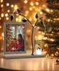 A festive Christmas scene with a photo frame, candle holder, and Christmas tree. Produktbild-Vorschau