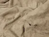 A close-up view of a crumpled beige towel. Náhled obrázku produktu