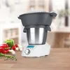 A multi-cooker appliance is shown on a wooden countertop with fresh vegetables in the foreground. Produktbild-Vorschau