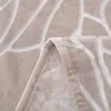 A close-up view of a folded beige blanket with a textured pattern. Podgląd zdjęcia produktu
