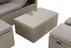A close-up view of a modular outdoor furniture set, including a coffee table and parts of a sofa and ottomans. Produktbild-Vorschau