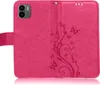 A pink flip case for a smartphone, with a floral and butterfly embossed pattern. Produktbild-Vorschau