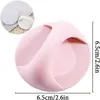 A pink, round adhesive handle is shown with a smaller inset image of two similar handles. Produktbild-Vorschau