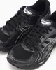 A close-up, eye-level shot of a pair of black ASICS running shoes. Produktbild-Vorschau