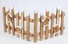 A small, decorative wooden fence with birdhouses attached, set against a white background. Náhled obrázku produktu