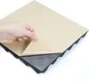 A hand is peeling back the protective paper from a black acoustic foam tile. Produktbild-Vorschau