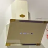 A cream-colored range hood with gold accents and a glass front panel displaying digital controls. Produktbild-Vorschau