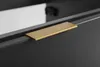 A close-up of a gold handle on a dark gray cabinet. Anteprima dell’immagine prodotto