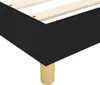 A close-up view of the corner of a bed frame with a dark fabric upholstery and wooden legs. Voir les images du produit