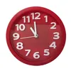 A red analog alarm clock with white numbers and hands, set against a white background. Produktbild-Vorschau