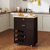 A kitchen cart with a wooden top, drawers, cabinets, and a wine rack, placed in a kitchen setting with cabinets and a countertop visible. Podgląd zdjęcia produktu