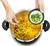 Hands adding ingredients to a pressure cooker filled with food. Podgląd zdjęcia produktu
