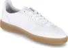 A white leather sneaker with a gum sole is shown from a side angle against a white background. Produktbild-Vorschau