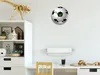 A child's room with a desk, shelves, and a wall clock. Produktbild-Vorschau