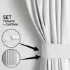 A close-up of a white curtain with a tieback, showing how it is used to hold the curtain in place. Produktbild-Vorschau