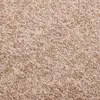 A close-up view of a beige carpet texture. Voir les images du produit