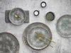 A top-down view of a table setting with plates, cutlery, and candles. Náhľad obrázku produktu