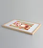 A framed picture with a woman's face and orange polka dots is displayed on a light gray surface. Produktbild-Vorschau