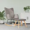 A taupe fabric rocking chair and ottoman are placed on a gray rug in front of a white cabinet. Produktbild-Vorschau