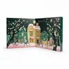 An open advent calendar depicting a winter village scene with people shopping. Produktbild-Vorschau