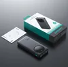 A black Joyroom power bank, its packaging, and user manual are displayed on a dark surface. Produktbild-Vorschau