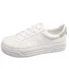 A white sneaker with embossed branding and a silver accent on the heel, shown from the side against a white background. Produktbild-Vorschau