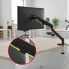 A monitor arm mounted on a desk in an office setting. Anteprima dell’immagine prodotto