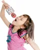 A young girl is singing into a pink karaoke microphone. Podgląd zdjęcia produktu