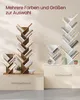 Two tree-shaped bookshelves, one in vintage brown and one in white, are displayed on pedestals. The brown bookshelf is smaller and has books on its shelves. The white bookshelf is larger and also has books. Text overlays indicate color and size options. Produktbild-Vorschau