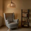 A cozy reading nook with a wingback chair and a bookshelf. Podgląd zdjęcia produktu