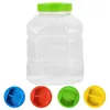 A clear plastic jar with a green lid, and four colored lids (blue, red, green, yellow) are displayed below it. Produktbild-Vorschau