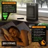A woman sleeping in bed next to a Brandson heater placed on a windowsill. Anteprima dell’immagine prodotto