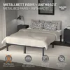 A metal bed frame with a mattress and pillows in a bedroom setting, with informational icons at the bottom. Náhled obrázku produktu