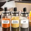 Three spice jars with labels on a kitchen counter. Podgląd zdjęcia produktu