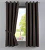 A pair of brown curtains tied back with a fabric tie, hanging in front of a window with a view of greenery and a pink vase on the windowsill. Produktbild-Vorschau